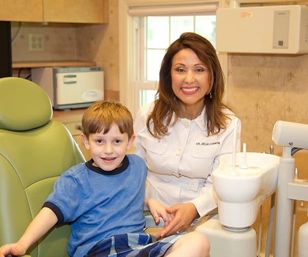 Dr. Cannon and young patient smiling in dental office