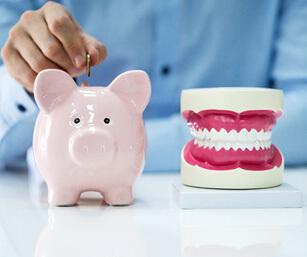 a man putting a coin in a piggy bak next to a jaw mockup