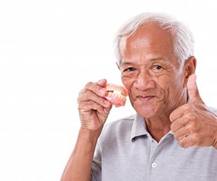 an older couple eating red apples