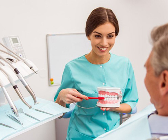 a patient at the dentist to receive dentures