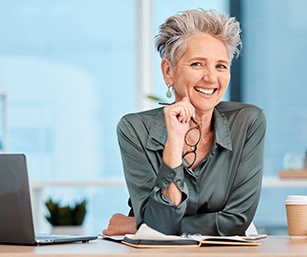 Woman smiling in office with dentures