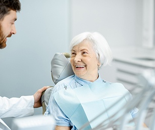 Denture dentist speaking with a patient