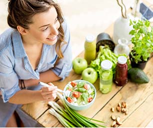 Woman eating a healthy meal and smiling