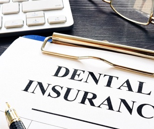 Dental insurance form on clipboard on a desk