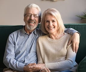 Older couple enjoying long-term benefits of dental implants