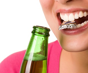 Woman holding a beer cap in her mouth