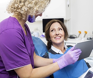 Dentist explaining cost of dental implants in Sparta to a patient