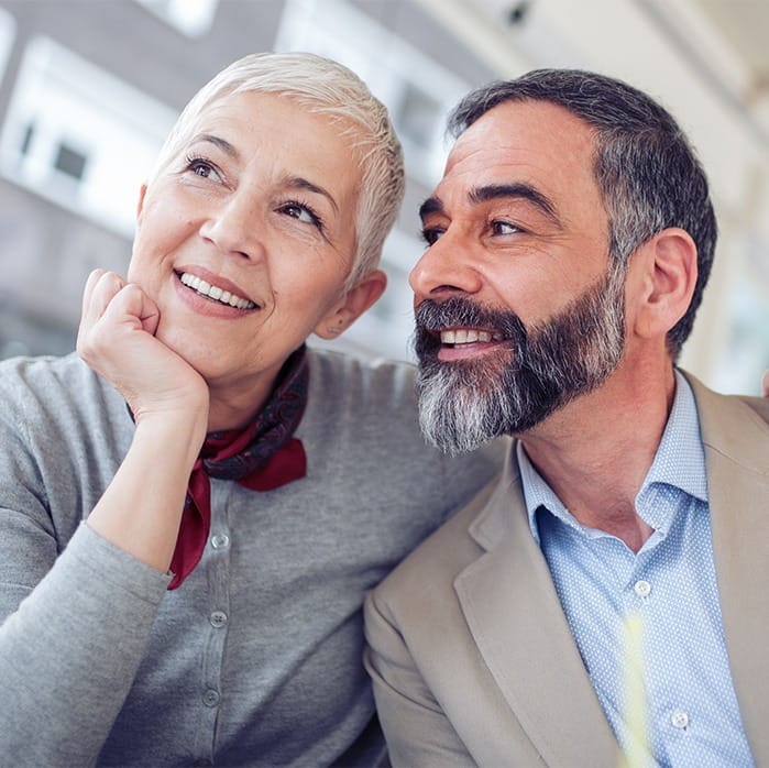 older couple smiling with dental implants in Sparta