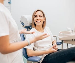 smiling woman talking to her dentist