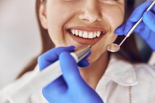 a patient smiling while undergoing a dental checkup