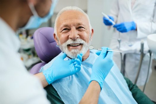 a patient smiling while visiting his dentist near Jefferson