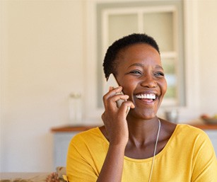 Woman smiling while talking on phone
