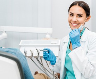 Dentist smiling at patient's dental exam