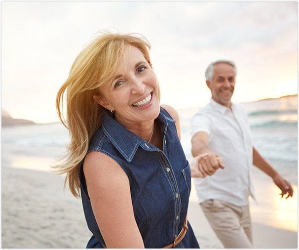 Smiling older man and woman at beach