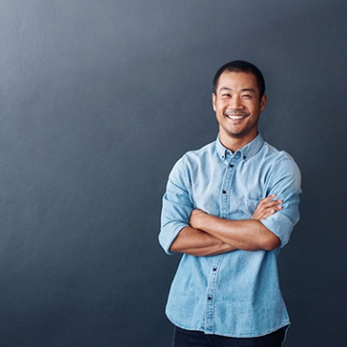 person smiling and crossing their arms