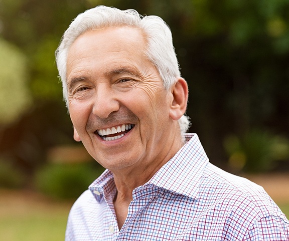 Senior man smiling after a full mouth reconstruction in Sparta, NJ