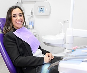Woman in black jacket sitting in dental chair