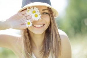 smiling woman flowers sun