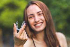 a woman smiling after finding her aligner