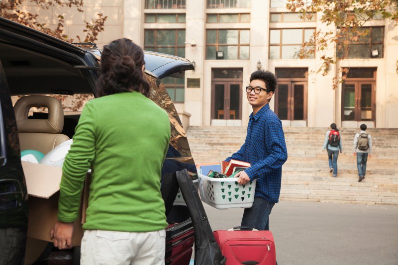 A college student preparing to settle into their dorm room