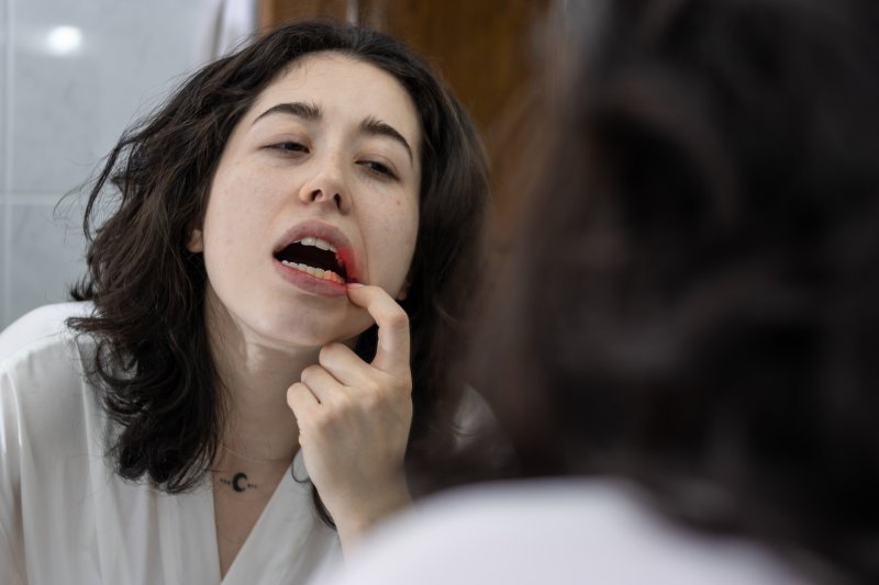 Patient checking for gum disease in mirror