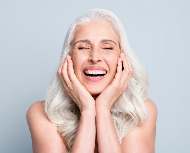 Senior woman cupping her face, smiling