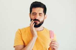 Man experiencing tooth sensitivity